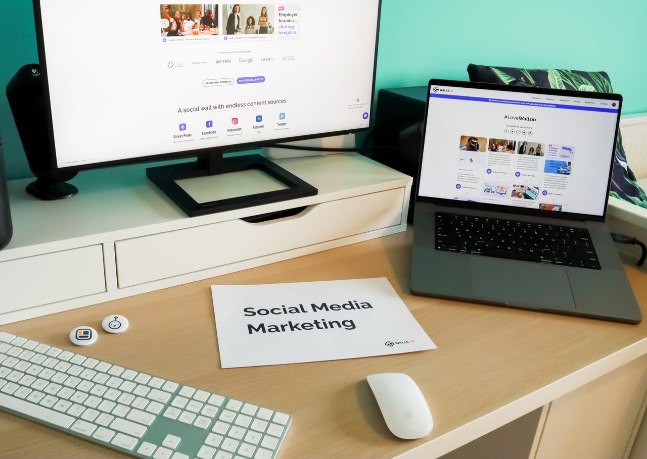 Stylish workspace with laptop and monitor for social media marketing.